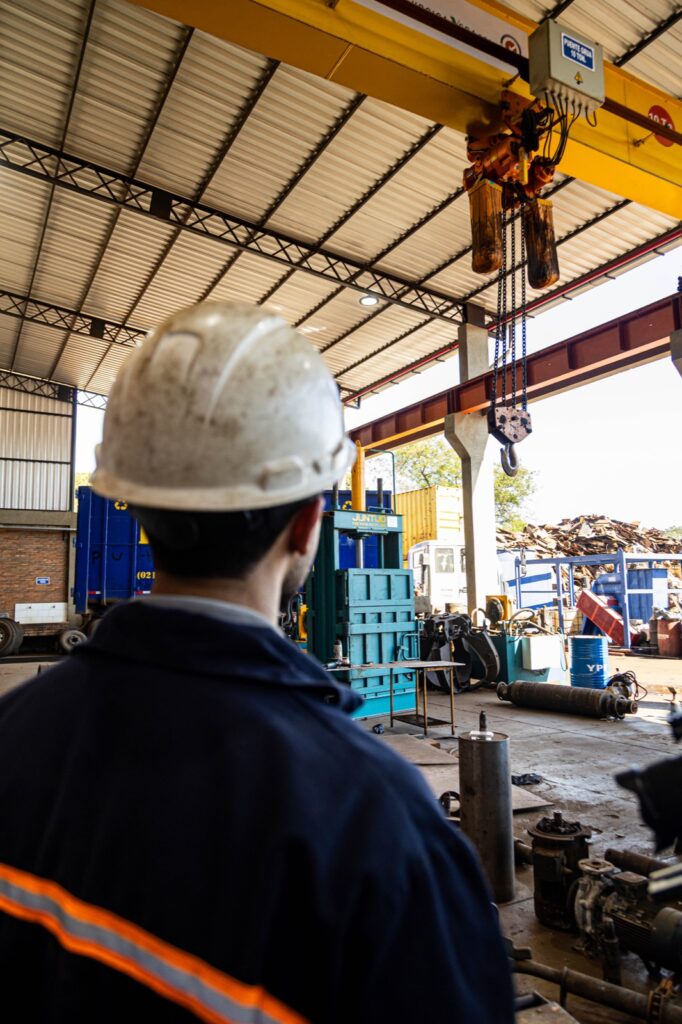 Operario junto a la prensa compactadora de metales en la planta de Brassur